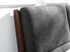 close-up of grey fabric and dark wood headboard