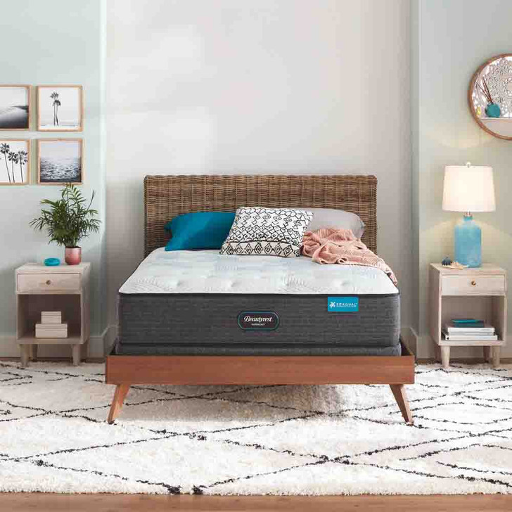 front view of the mattress on a wooden bed in a furnished bedroom